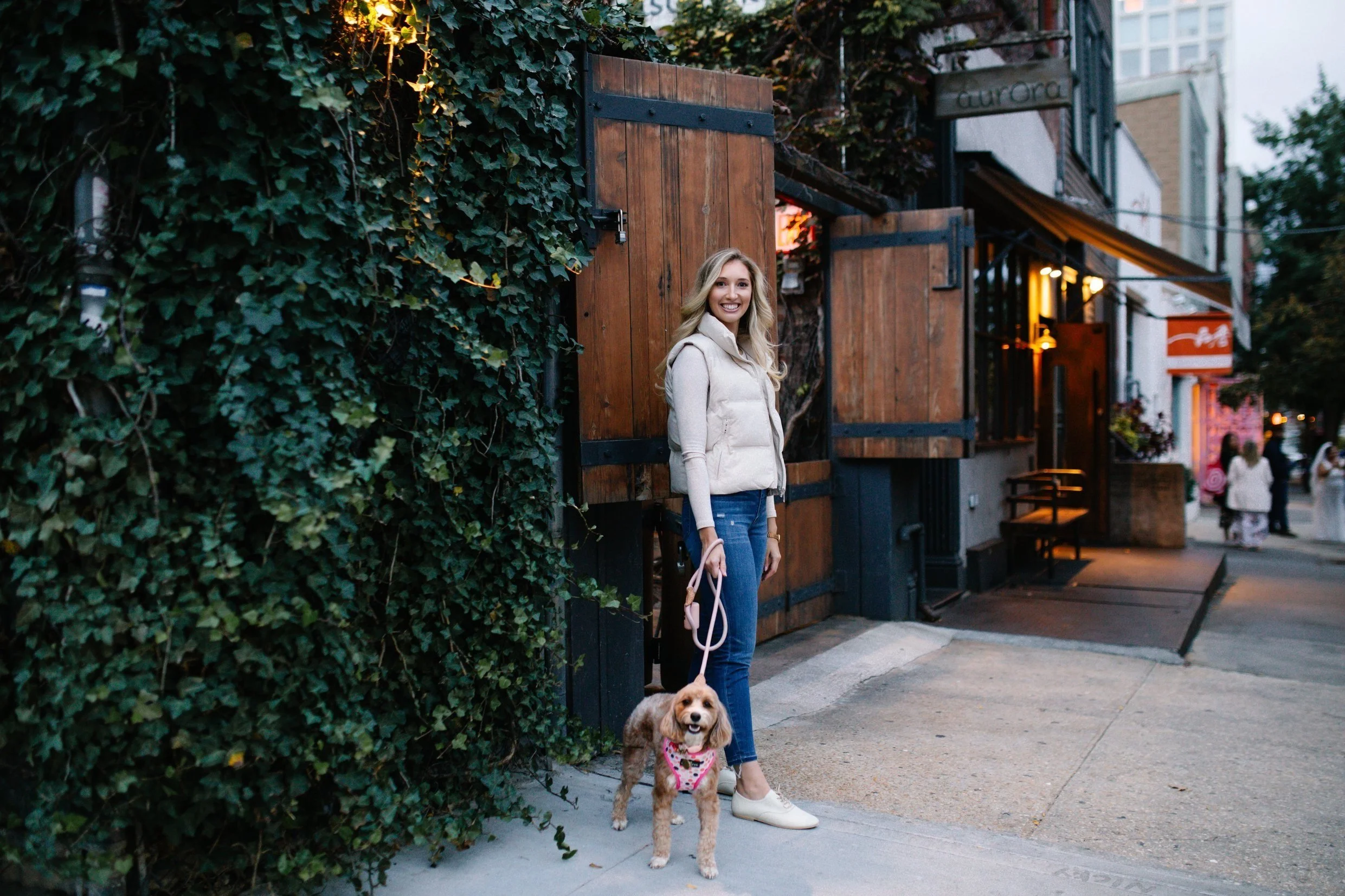 May Babraitis walking a dog in the city