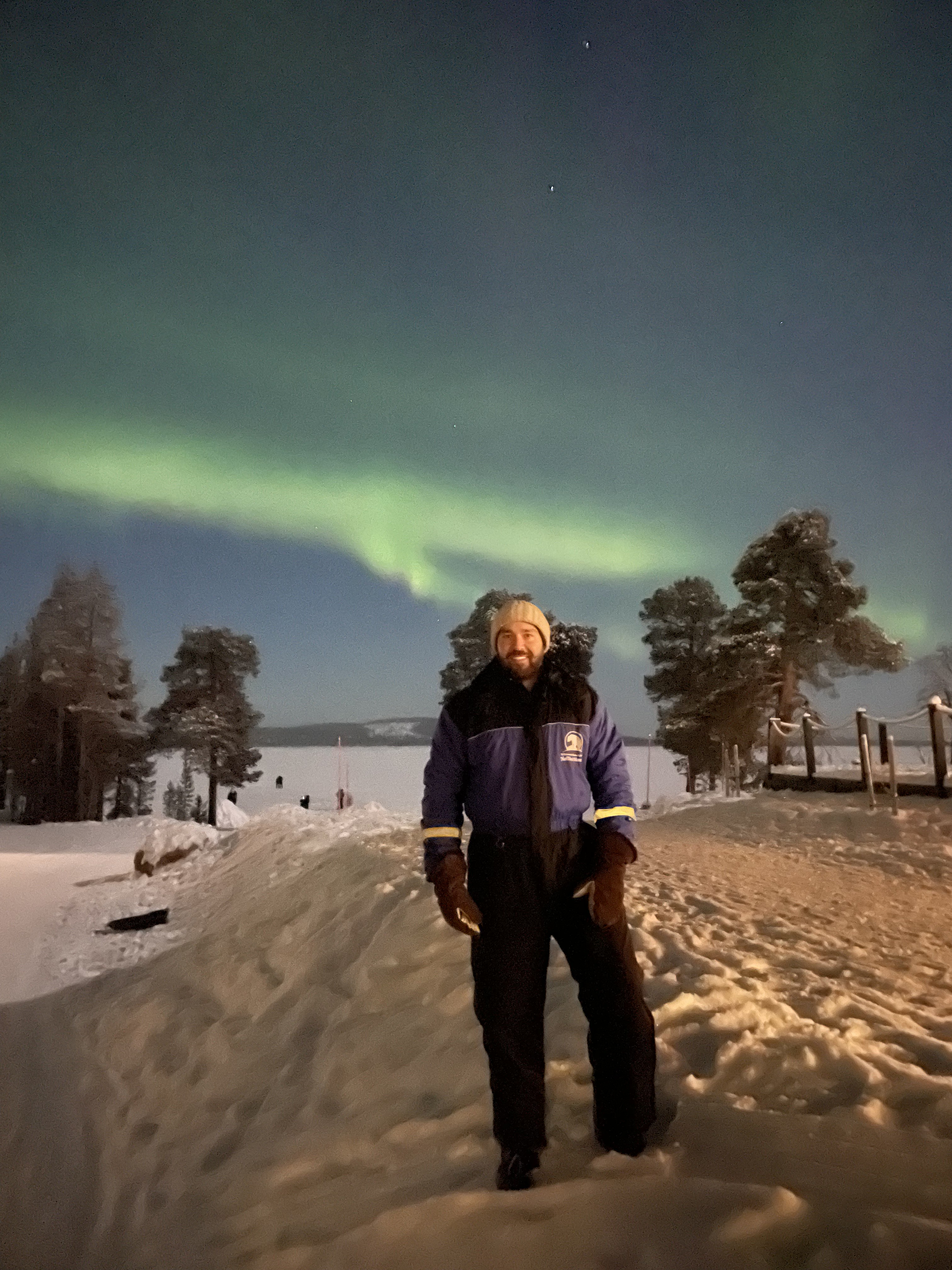 Matt standing in the snow beneath the northern lights