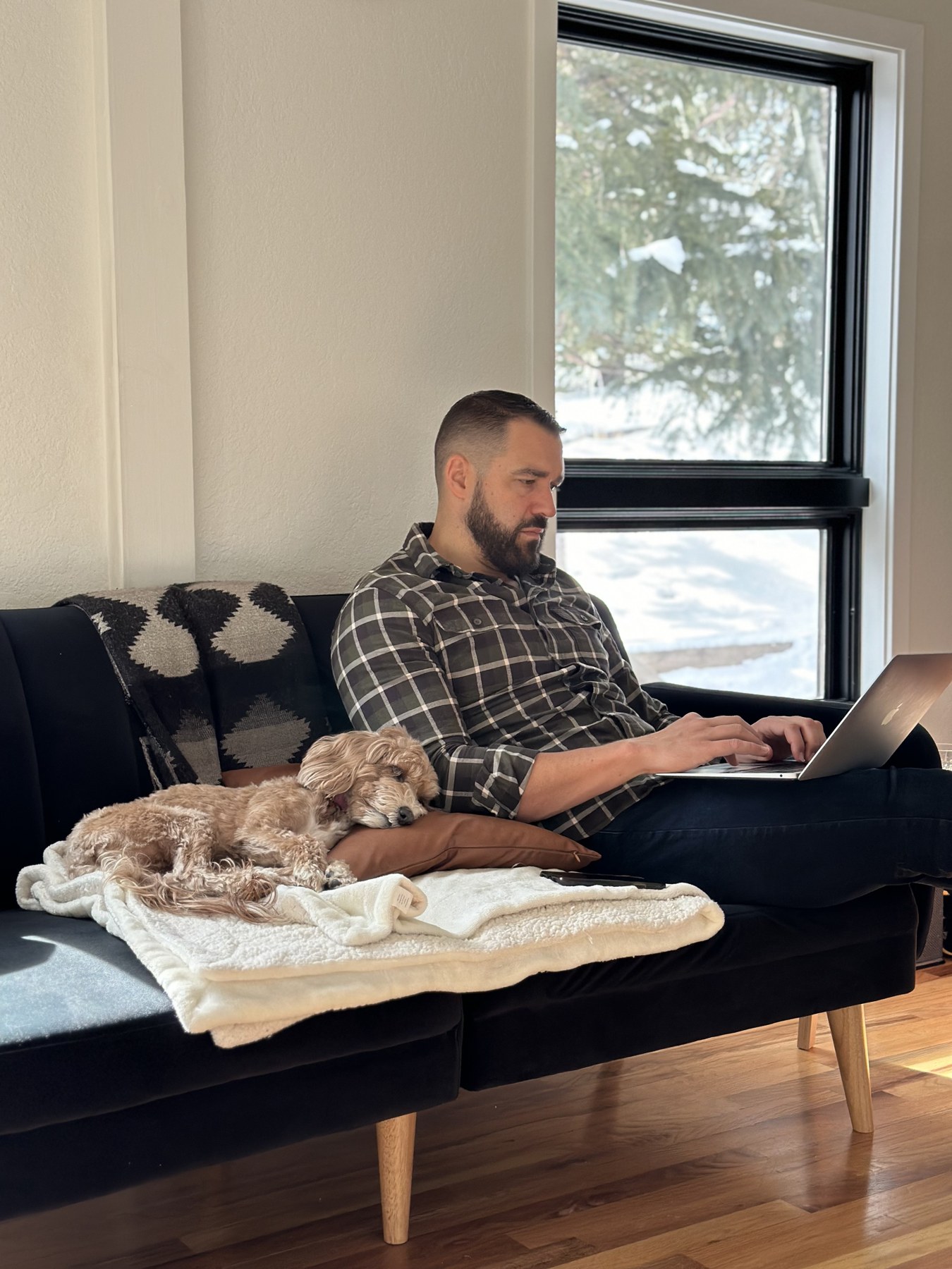 Working on a laptop beside a sleeping dog